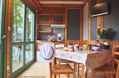 a kitchen with a table and chairs and a kitchen with a tableablish at Chalet Park Jouillat 