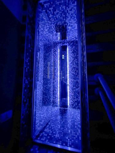 a door in a brick building with blue lights at Muricis in Santeramo in Colle