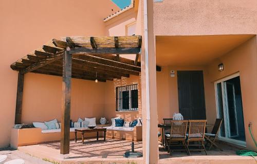 a patio with a wooden pergola on a house at Manilva Beach 140 in Manilva