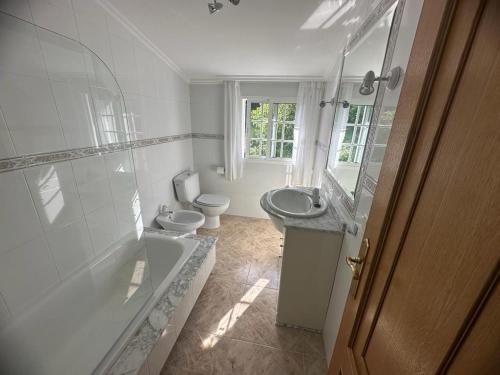 a bathroom with a tub and a sink and a toilet at O Castro Sanxenxo in Sanxenxo