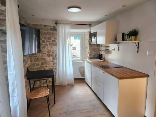a kitchen with a counter and a table in a room at Studios in old town in Split