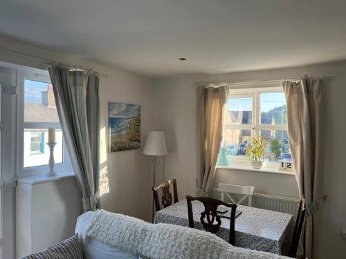 a bedroom with a bed and a table and a window at Beau retreat lovely apartment in Beaumaris in Beaumaris