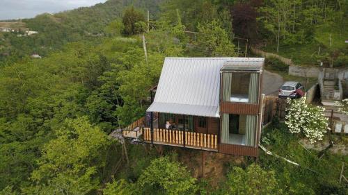 a house on a hill with a white roof at chemi kera Chalet in Makho