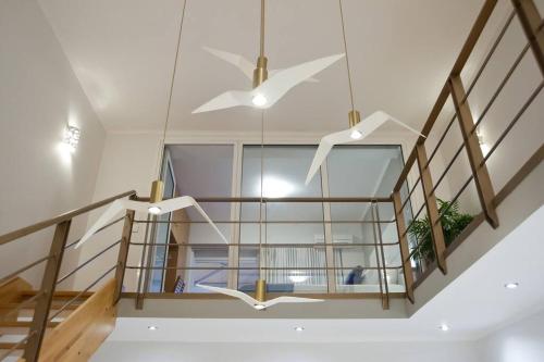 a staircase with a glass case and a ceiling fan at Seagull Luxury Maisonette in Itea