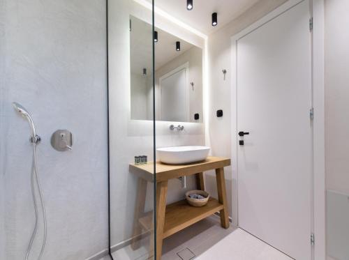 a bathroom with a sink and a shower at Anemones Villas by Omikron Selections in Spanokhórion