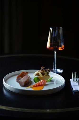a plate of food on a table with a glass of wine at The Killarney Park in Killarney