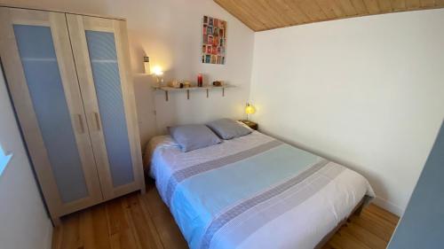 een kleine slaapkamer met een bed en een kast bij Mas Le Corbery in Largentière