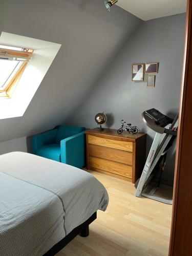 1 dormitorio con cama, silla y escritorio en Chambre, en Roézé-sur-Sarthe