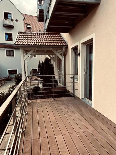 a porch of a house with a wooden deck at Hübsches Design Apartment mit Parkplatz im Zentrum von Königstein in Königstein an der Elbe