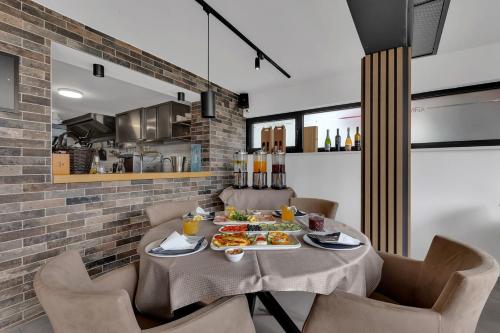 a dining room with a table with food on it at Beach Hotel Božikovina in Podstrana