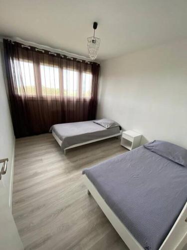 a bedroom with two beds and a window at Appartement Gien in Gien