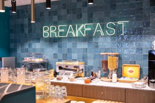 a break east sign on a blue tiled wall at B&B HOTEL Namur in Namur