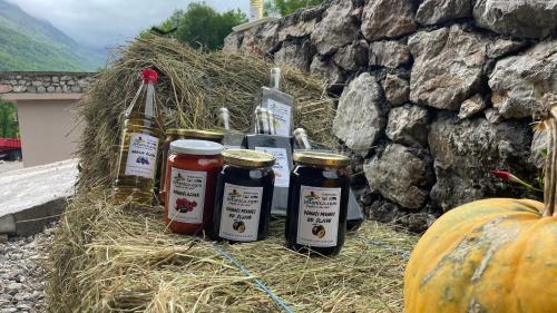 a group of bottles of wine sitting on hay next to a pumpkin at Josanica Bed&Breakfast in Konjic