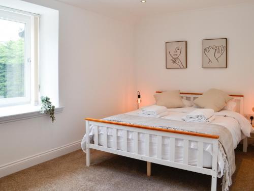 - un lit blanc dans une chambre avec fenêtre dans l'établissement Kirroughtree Steading 2 - Uk42904, à Newton Stewart