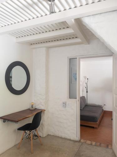 a room with a desk and a bed and a mirror at Salt Nosara in Nosara