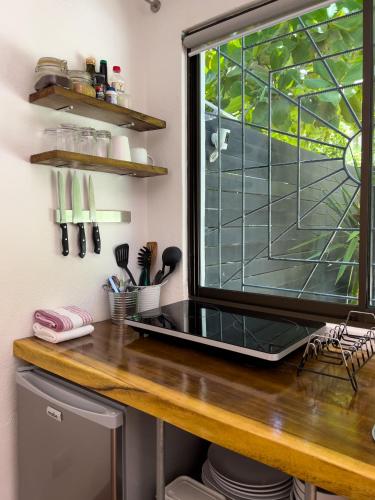 a laptop sitting on a wooden counter in a kitchen at Salt Nosara in Nosara