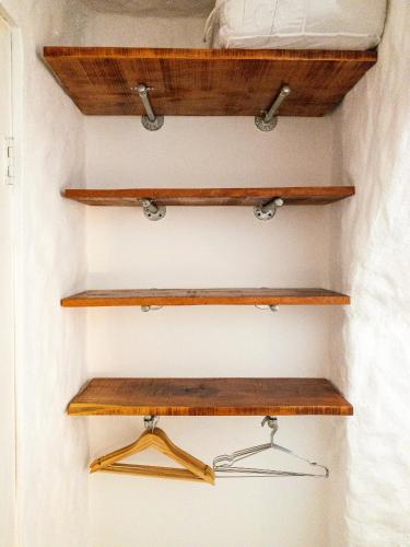 a closet with wooden shelves in a room at Salt Nosara in Nosara