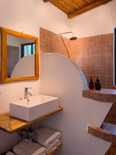 a bathroom with a sink and a mirror at Salt Nosara in Nosara
