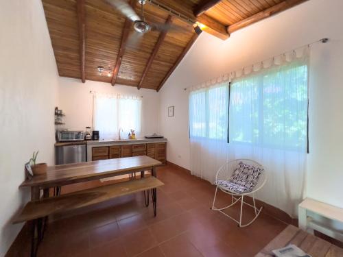 a kitchen with a wooden table and a chair at Salt Nosara in Nosara