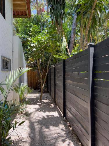 a wooden fence in front of a house at Salt Nosara in Nosara