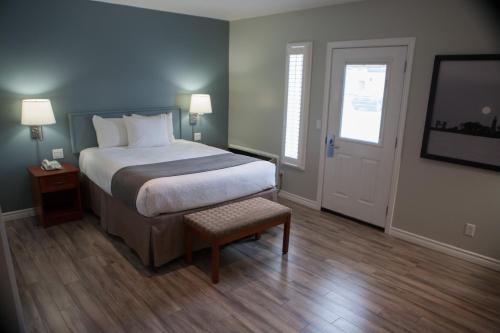 a bedroom with a bed and a window and a television at Super 8 by Wyndham Port Elgin in Port Elgin