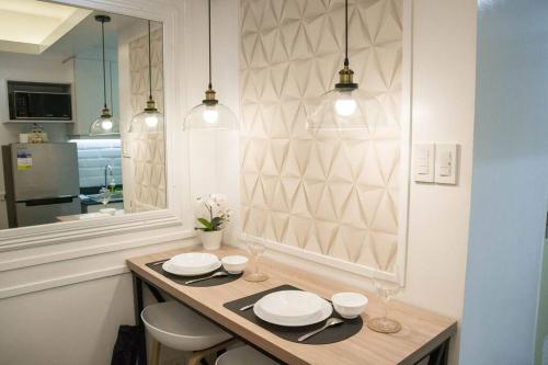 a kitchen with a table and two chairs and a mirror at Sea Residences - Classy Unit Near Mall of Asia, Arena, Ayala, Ikea, Okada, SMX, PITX, Airport in Manila