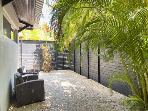 a patio with two chairs and a fence at Salt Nosara in Nosara