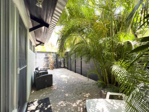 a courtyard of a house with palm trees at Salt Nosara in Nosara