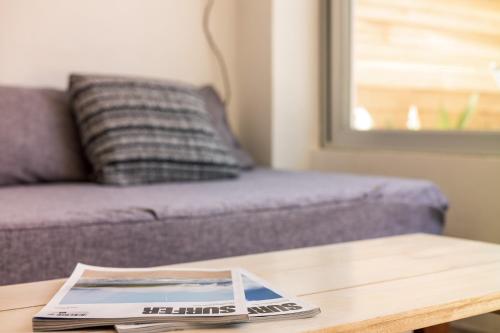 a magazine sitting on a coffee table with a couch at Salt Nosara in Nosara