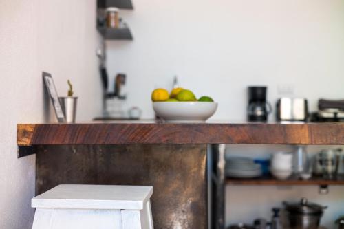 a kitchen counter with a bowl of fruit on it at Salt Nosara in Nosara