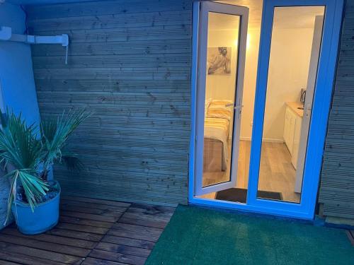 a sliding glass door leading to a bathroom with a bedroom at Abrilove in Castres