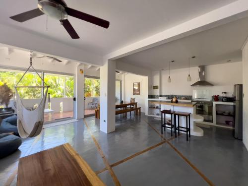 an open kitchen and living room with a swing at Salt Nosara in Nosara