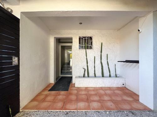 a hallway of a house with a door and a tile floor at Salt Nosara in Nosara