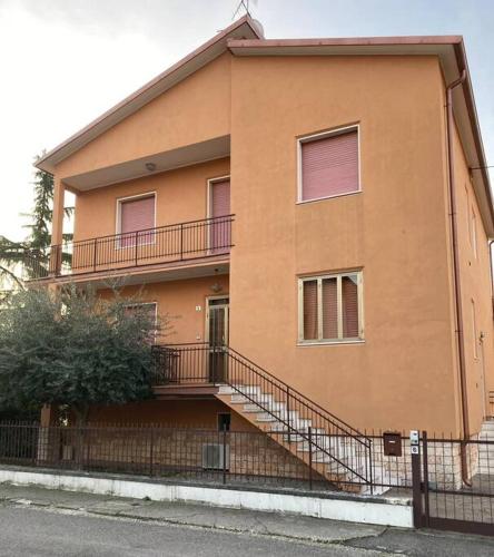 a building with a balcony and stairs on it at Casa Morena in Negrar