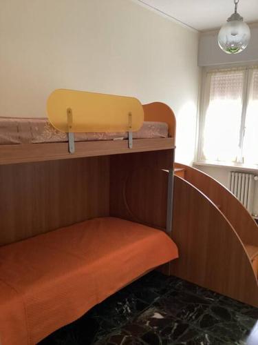 a bedroom with a bunk bed with a surfboard on a shelf at Casa Morena in Negrar