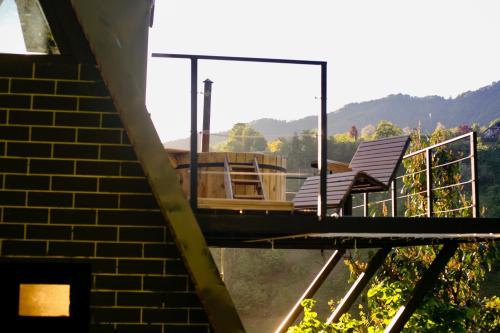 Merisi的住宿－GreenWood Cottages Merisi，房屋顶部的甲板上摆放着两把椅子