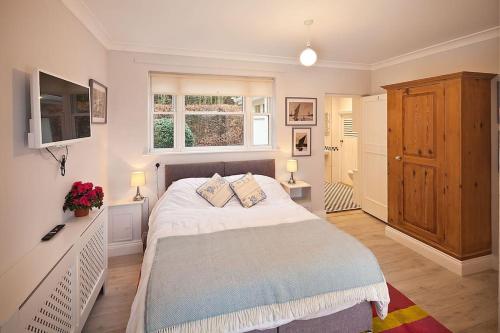 a bedroom with a large bed with two pillows on it at River Views, Beccles - HOT TUB + Norfolk Broads in Beccles