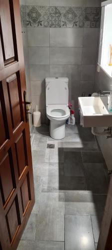 a bathroom with a white toilet and a sink at Traditional House in Skiros