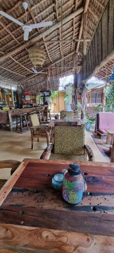 a wooden table with vases on top of it at Salama & Mbuyuni Bungalows in Matemwe