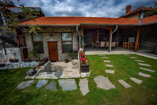 a house with a patio and a yard at Къща за приятели Недкови in Vasil Levski
