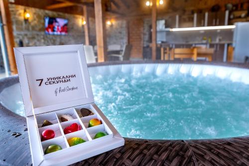 a box of chocolates next to a swimming pool at Къща за приятели Недкови in Vasil Levski