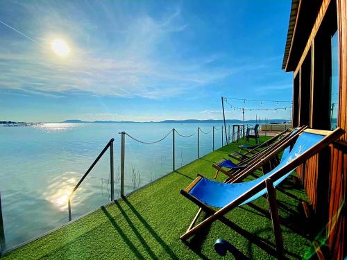 a balcony with a view of the water at BL LAKESIDE APARTMAN in Balatonlelle