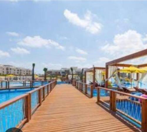 a boardwalk leading to a swimming pool on a pier at Amwaj amazing see view in Marsa Matruh