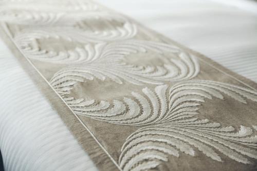a close up of a white pattern on a table at The Anya Hotel-Golf Course Road in Gurgaon