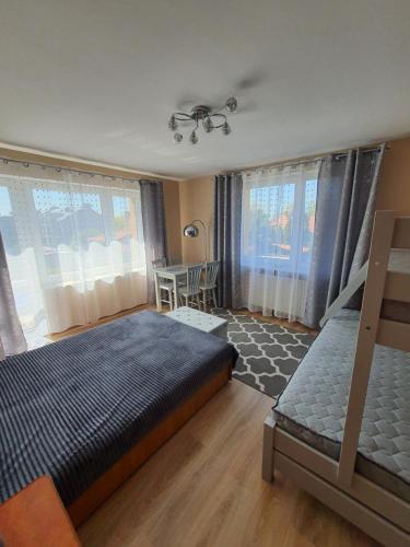 a bedroom with two bunk beds and a table at u eli i jurka in Sztutowo