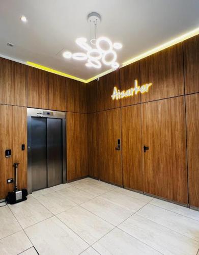 a room with wooden walls and a hallway with a elevator at Aizarker in La Plata