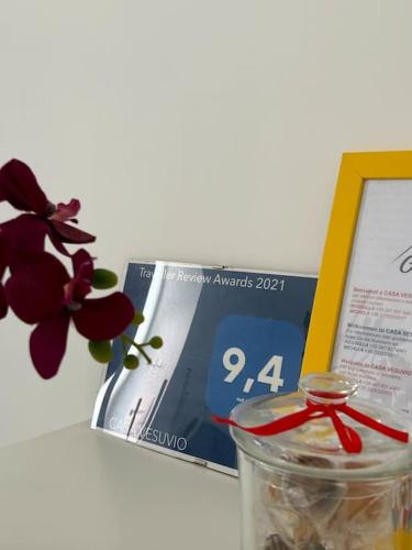 a book and a glass jar with a red ribbon at casa Vesuvio in Cercola