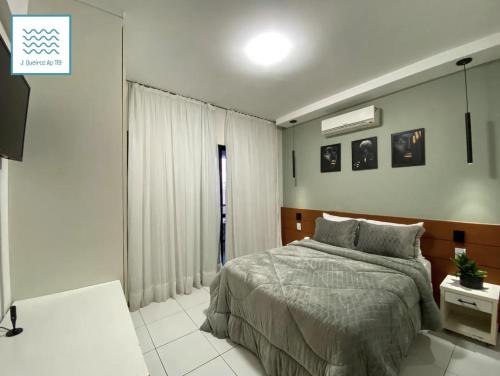 a bedroom with a bed and a window at Flat Luxuoso-Piscina, Praia e Serviço de Camareira in Salvador