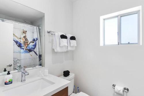 uma casa de banho branca com um lavatório e uma janela em DTPH Modern Designer Studio - Pool & Parking - em Phoenix