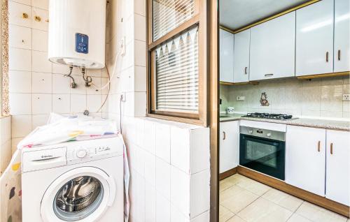 a kitchen with a washing machine and a window at Lovely Home In Santa Pola De Lest With House Sea View in Gran Alacant